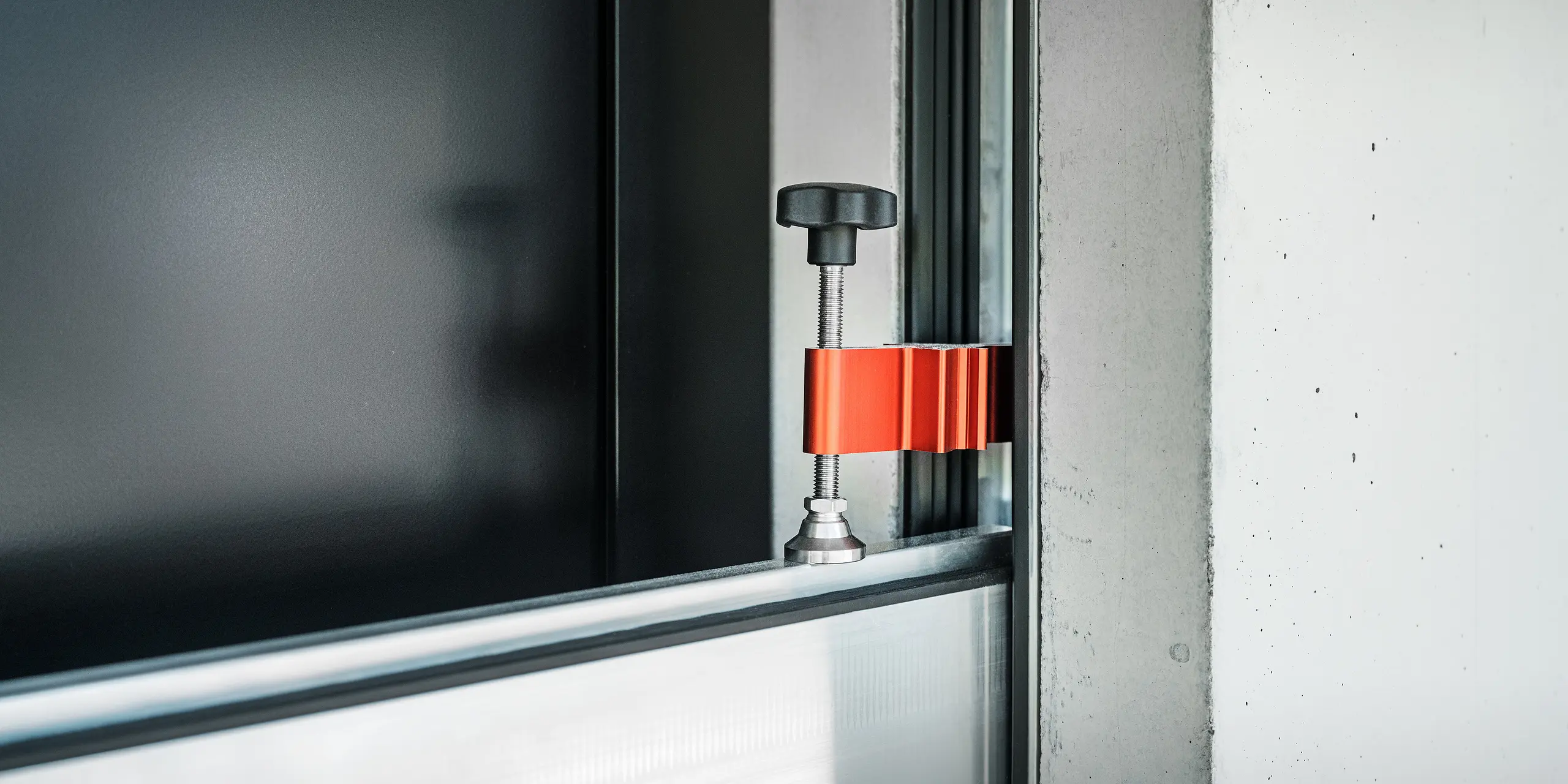 Das PREFA Hochwasserschutzsystem im Einsatz an der Eingangstür eines Einfamilienhauses. Das Spannstück hält die stabilen Aluminiumprofile zusammen und verhindert zuverlässig das Eindringen von Wasser.