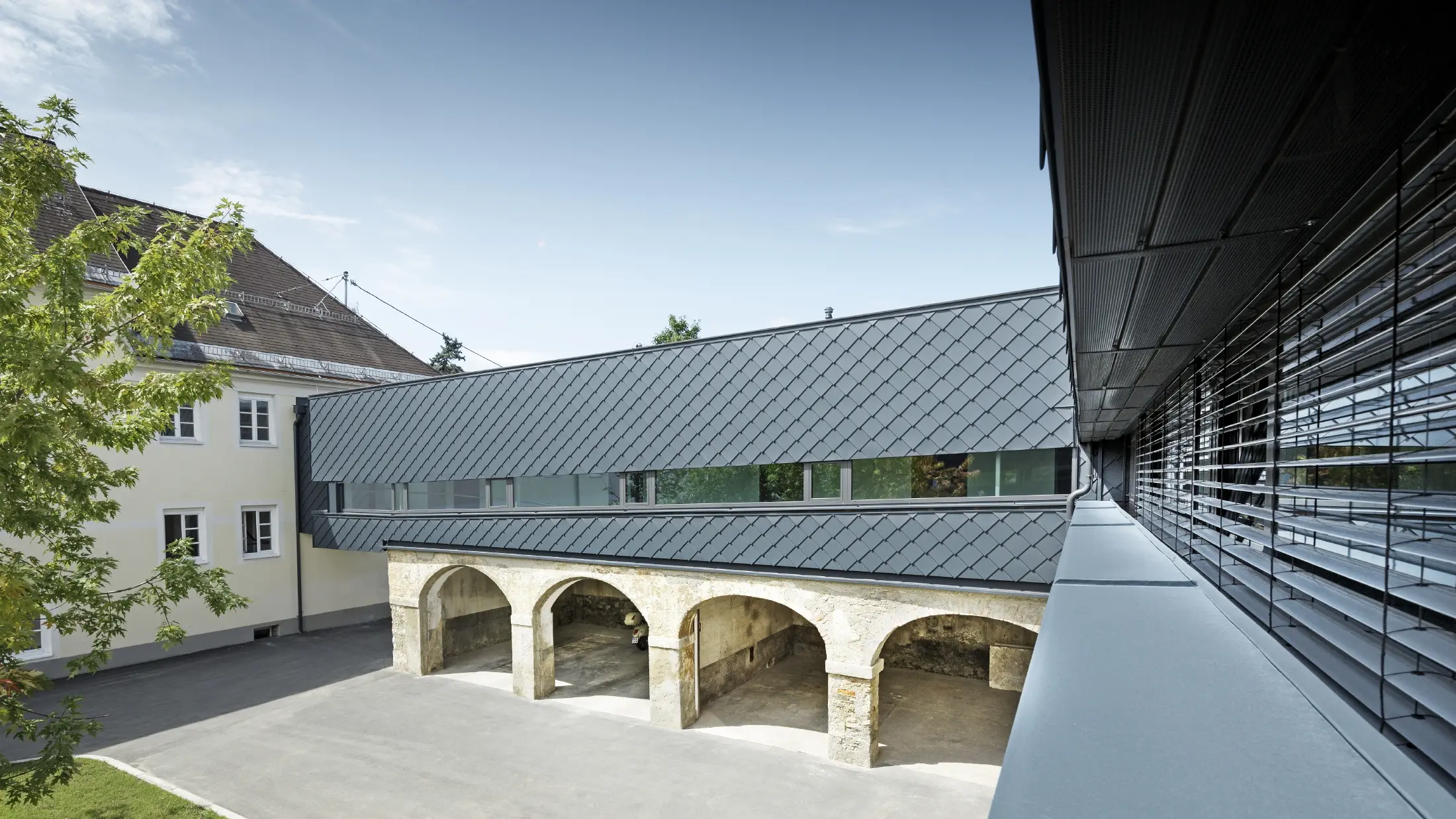 Budynek objęty ochroną konserwatorską został pokryty na piętrze rombem elewacyjnym PREFA 29 w kolorze antracyt, dzięki czemu stare struktury na parterze idealnie harmonizują z nowymi rombami.