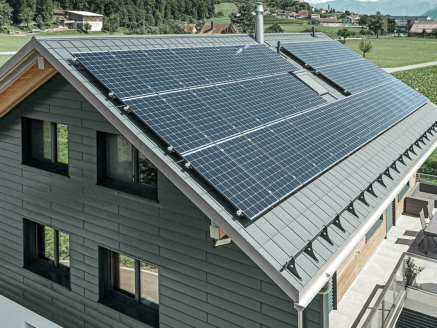 Instalacja fotowoltaiczna zamontowana na dachu PREFA z wspornikami solarnymi i szyną montażową do stabilnego mocowania.
