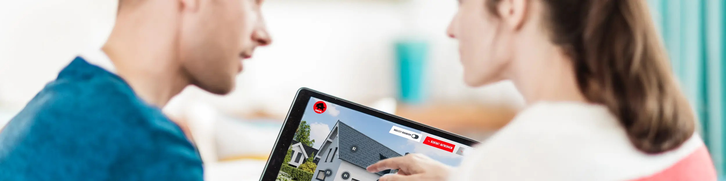 Para siedzi przy stole i ogląda na tablecie fotografię domu z dachem, elewacją i elementami solarnymi z aluminium – w kontekście poradnika PREFA dla dachów, elewacji i fotowoltaiki w nowych inwestycjach i remontach.